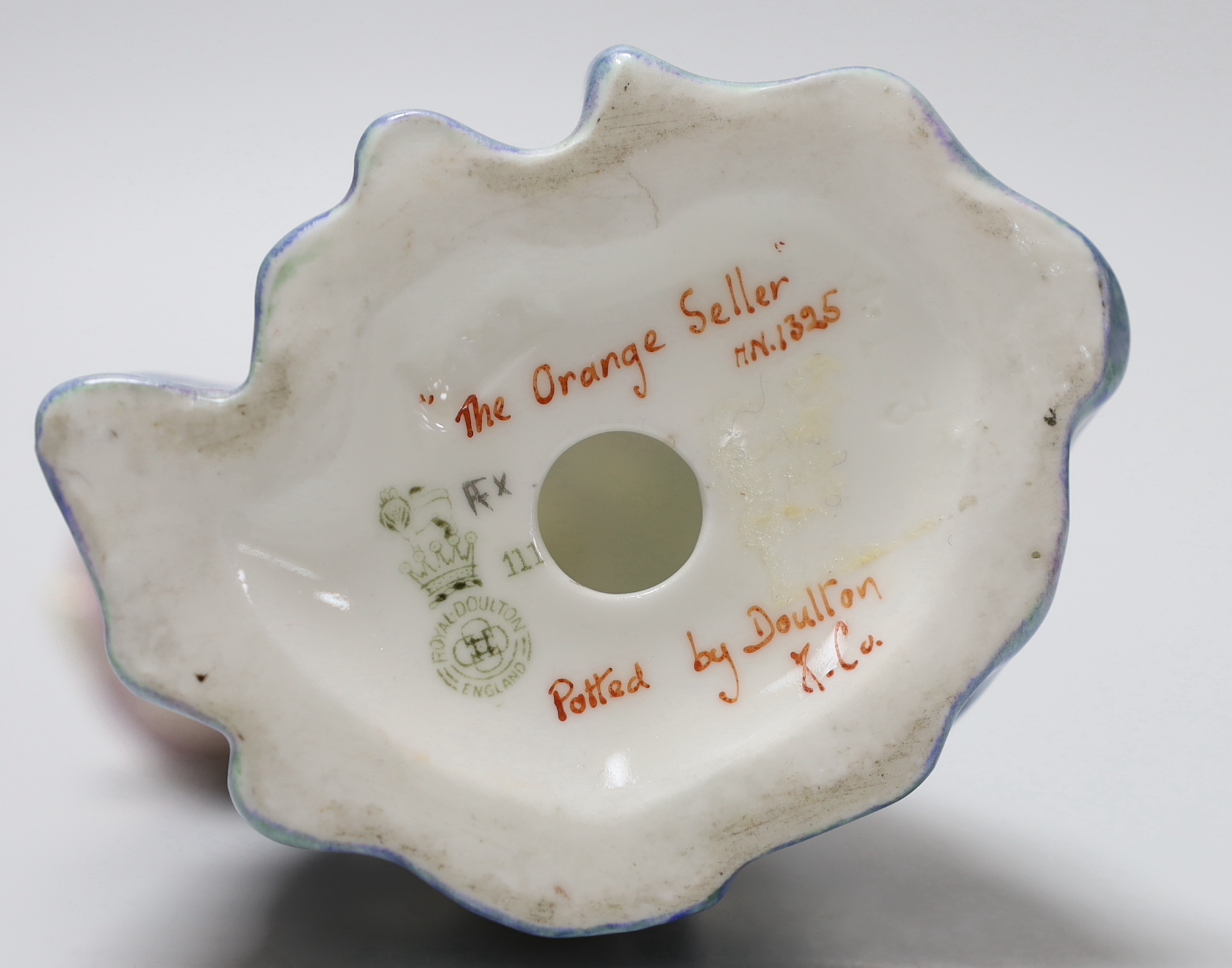 A Royal Doulton figure 'The Orange Seller, HN1325, inscribed to the base 18.5cm high